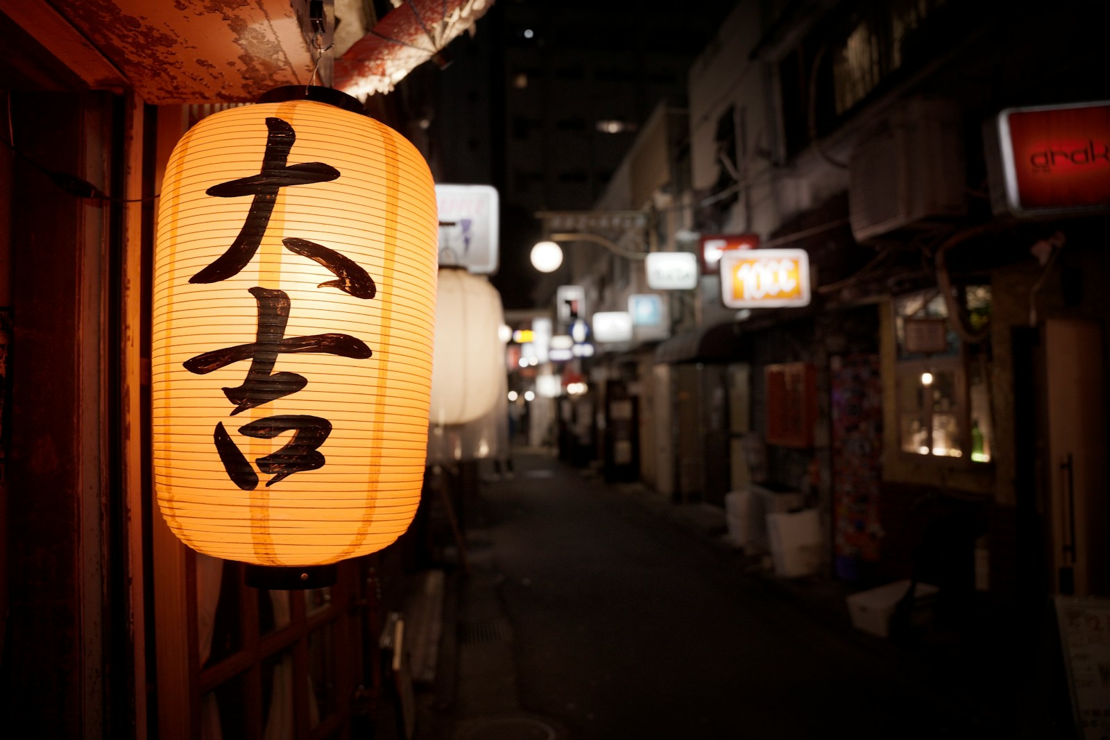 A lantern hanging from the side of a building